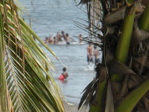 Outside the tourist hotel local children swim in a National Geographic idyll though right here the water isn't pristine