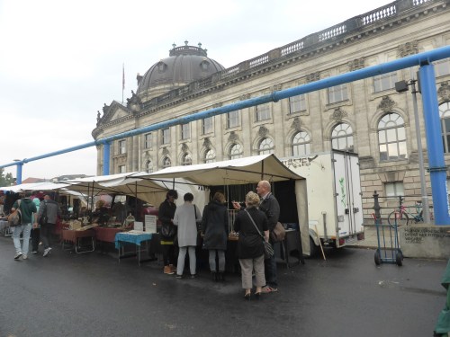 The Sunday antique market with the ever present  blue  pipe perpetually draining the swamp below the city.